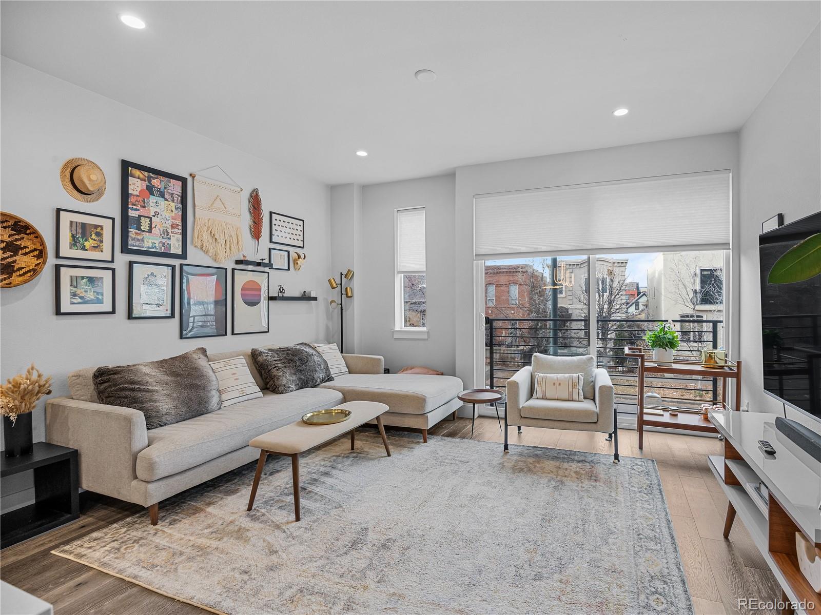 2350 Tremont Place, Unit 6 Denver, CO 80205 - Photo 17 of 40 a living room with furniture and a flat screen tv