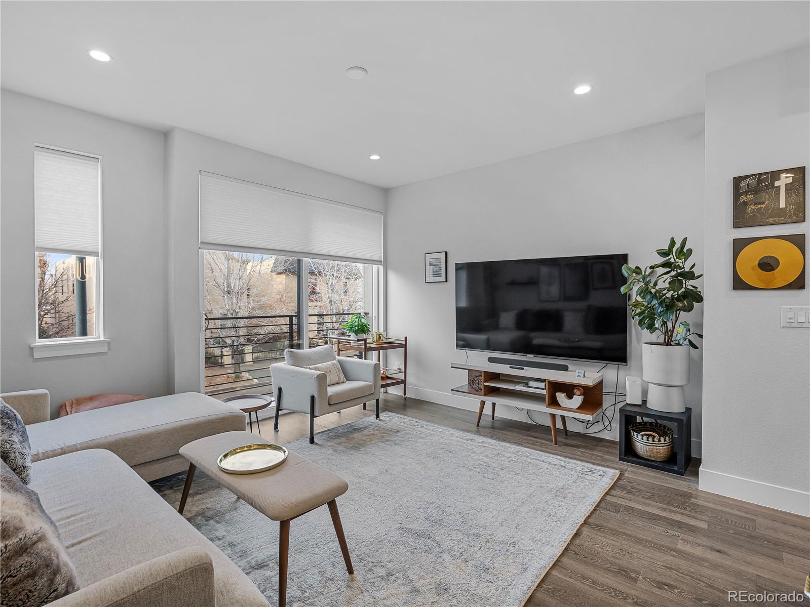 2350 Tremont Place, Unit 6 Denver, CO 80205 - Photo 18 of 40 a living room with furniture and a flat screen tv