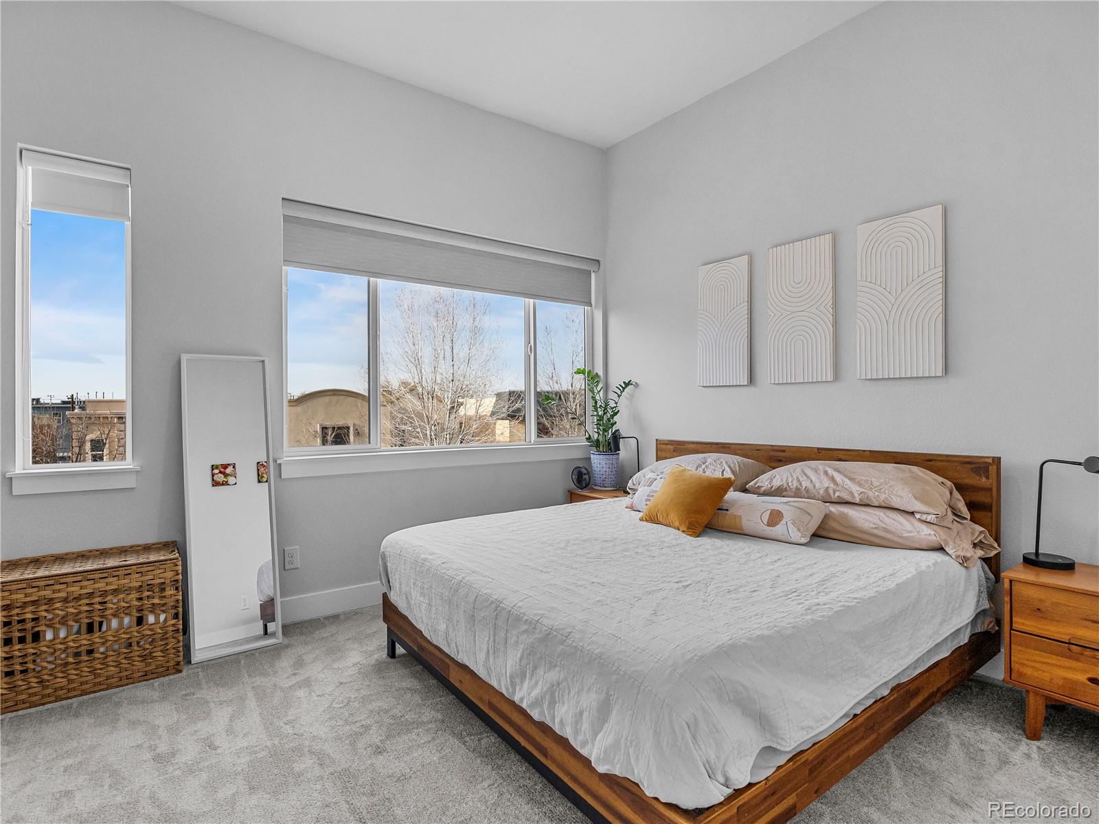 2350 Tremont Place, Unit 6 Denver, CO 80205 - Photo 22 of 40 a bedroom with a bed and a cabinets