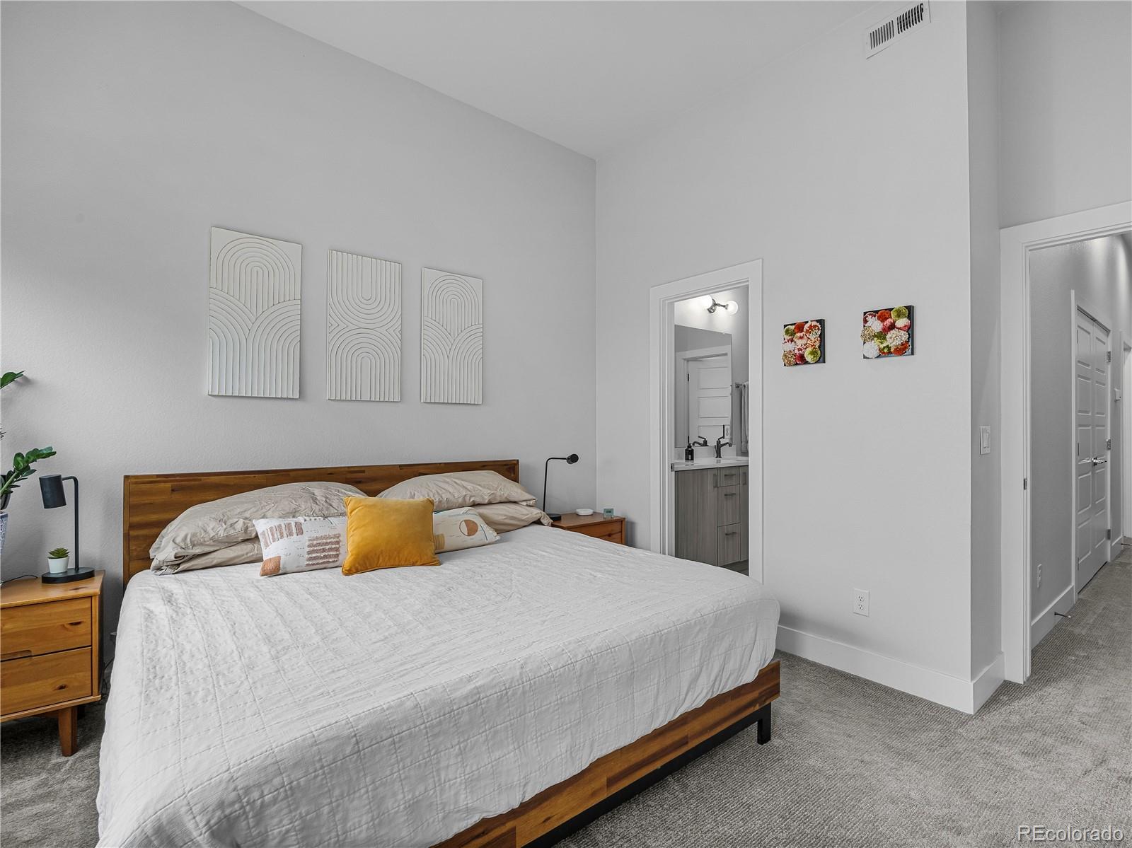 2350 Tremont Place, Unit 6 Denver, CO 80205 - Photo 23 of 40 a bedroom with a bed and a couch