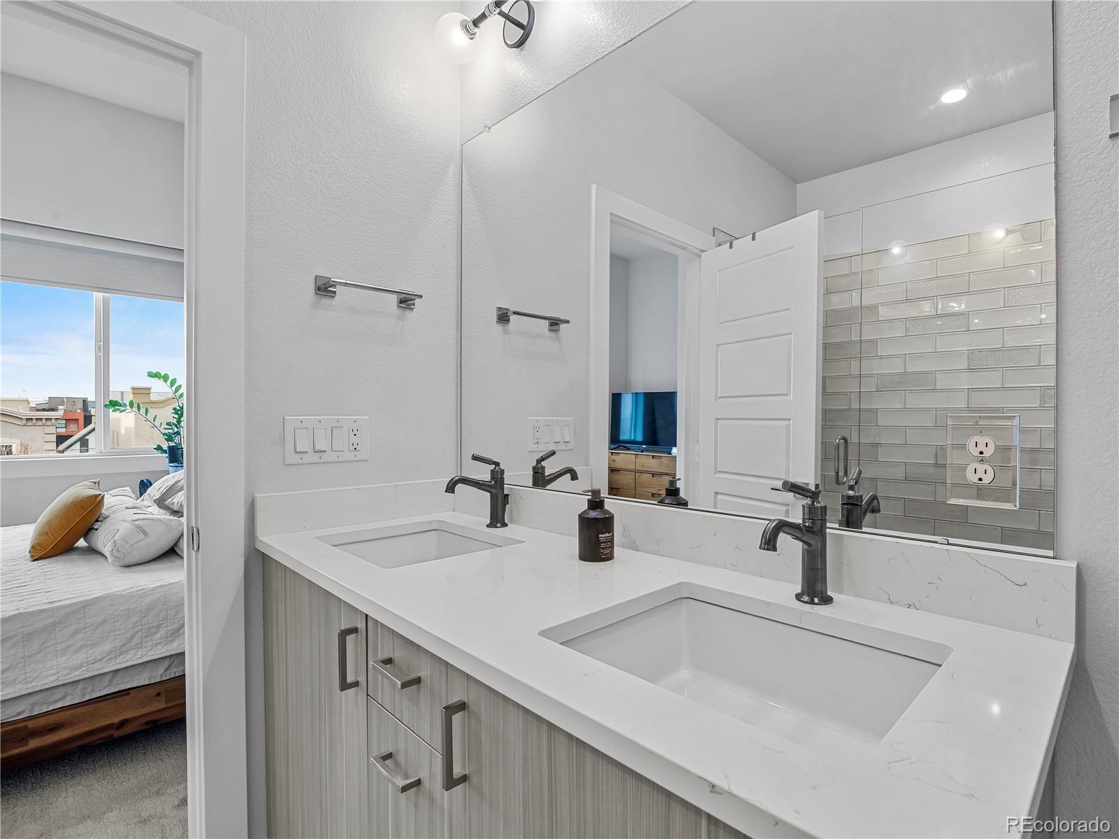 2350 Tremont Place, Unit 6 Denver, CO 80205 - Photo 27 of 40 a bathroom with 2 sink and a mirror