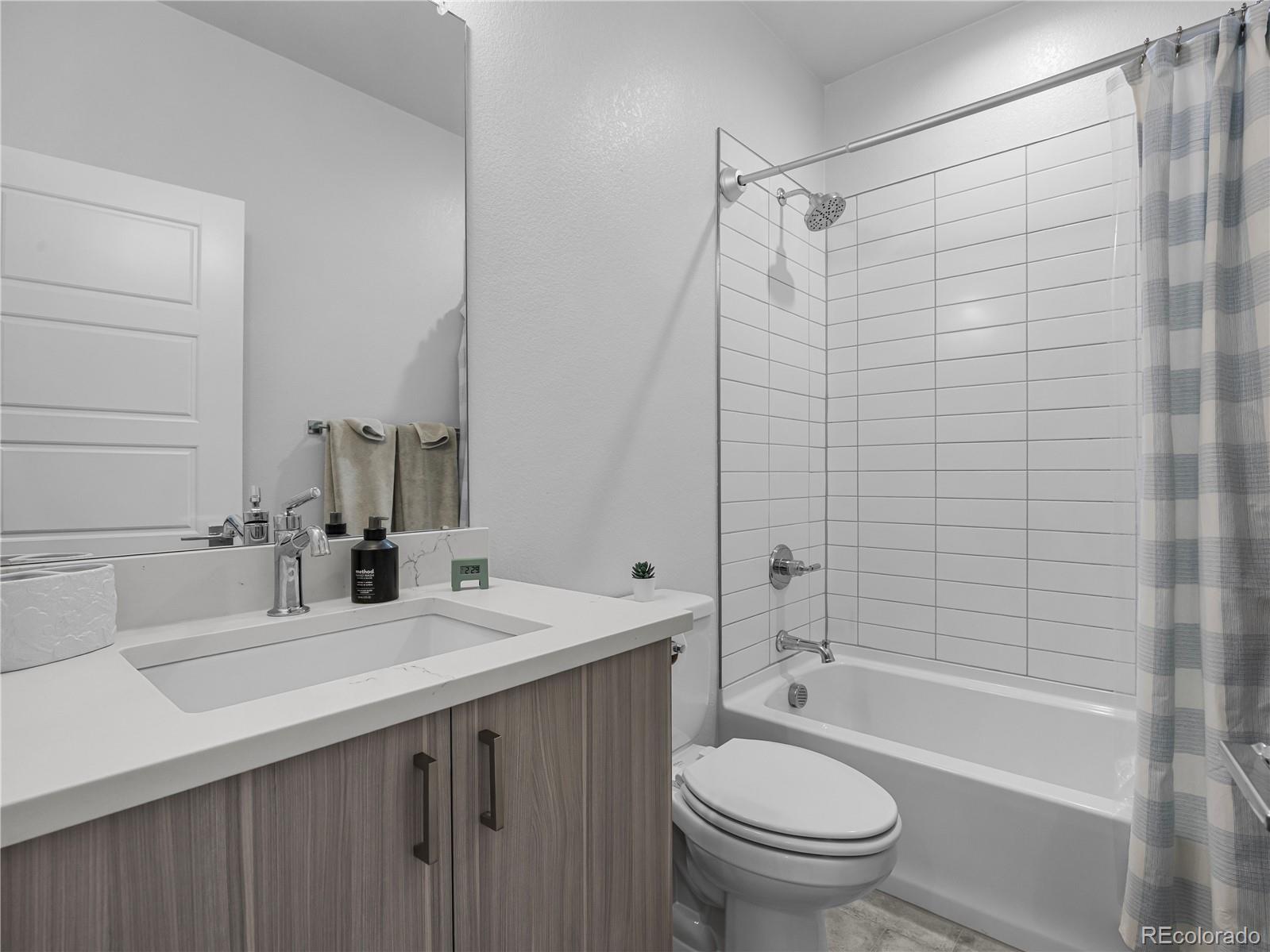 2350 Tremont Place, Unit 6 Denver, CO 80205 - Photo 30 of 40 a bathroom with a sink a toilet and a bathtub