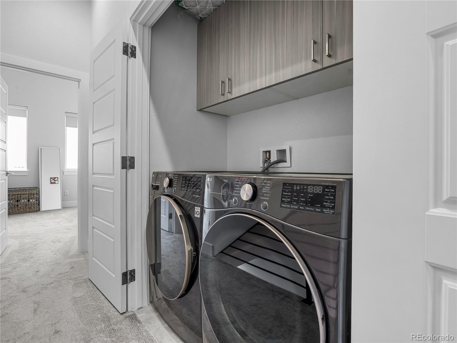 2350 Tremont Place, Unit 6 Denver, CO 80205 - Photo 31 of 40 a utility room with dryer and washer