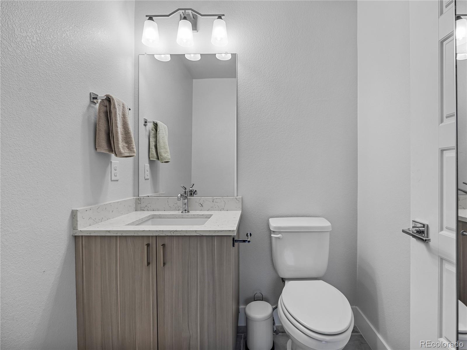 2350 Tremont Place, Unit 6 Denver, CO 80205 - Photo 35 of 40 a bathroom with a toilet sink and mirror