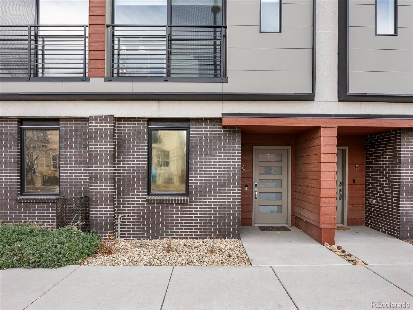 2350 Tremont Place, Unit 6 Denver, CO 80205 - Photo 4 of 40 a view of a brick house with large windows