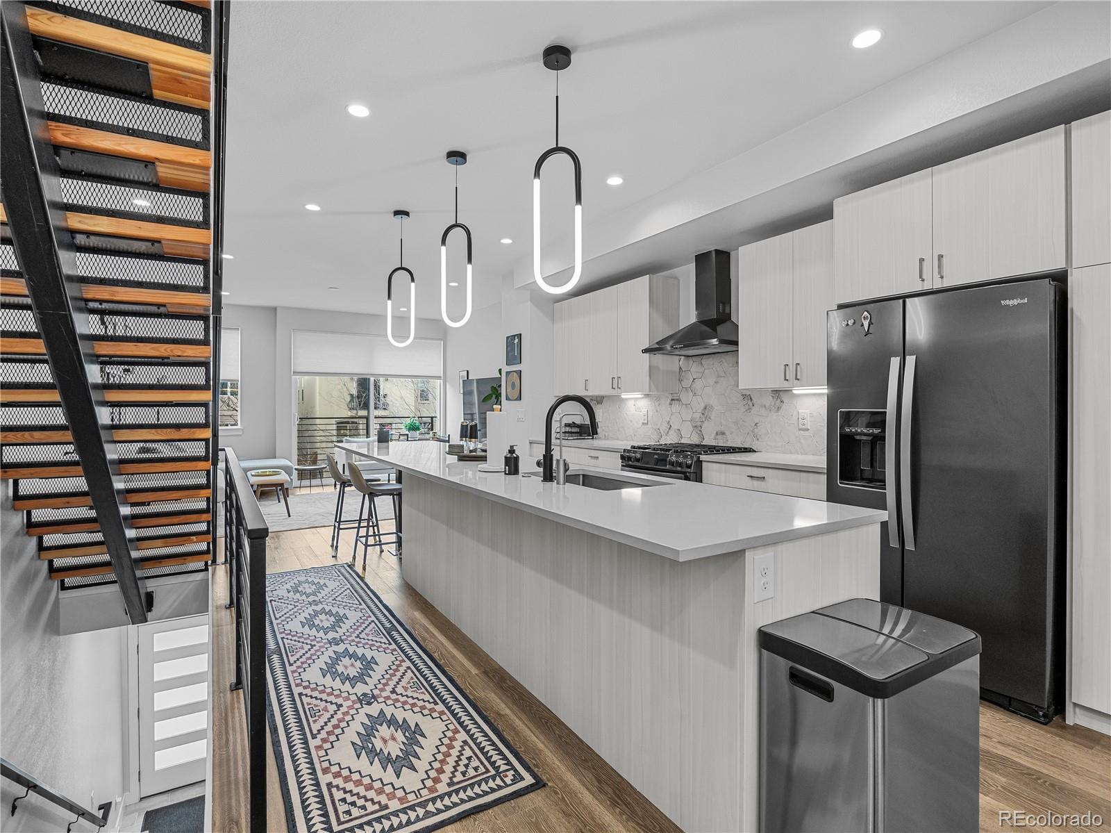 2350 Tremont Place, Unit 6 Denver, CO 80205 - Photo 8 of 40 a kitchen with stainless steel appliances a sink a stove a refrigerator and cabinets