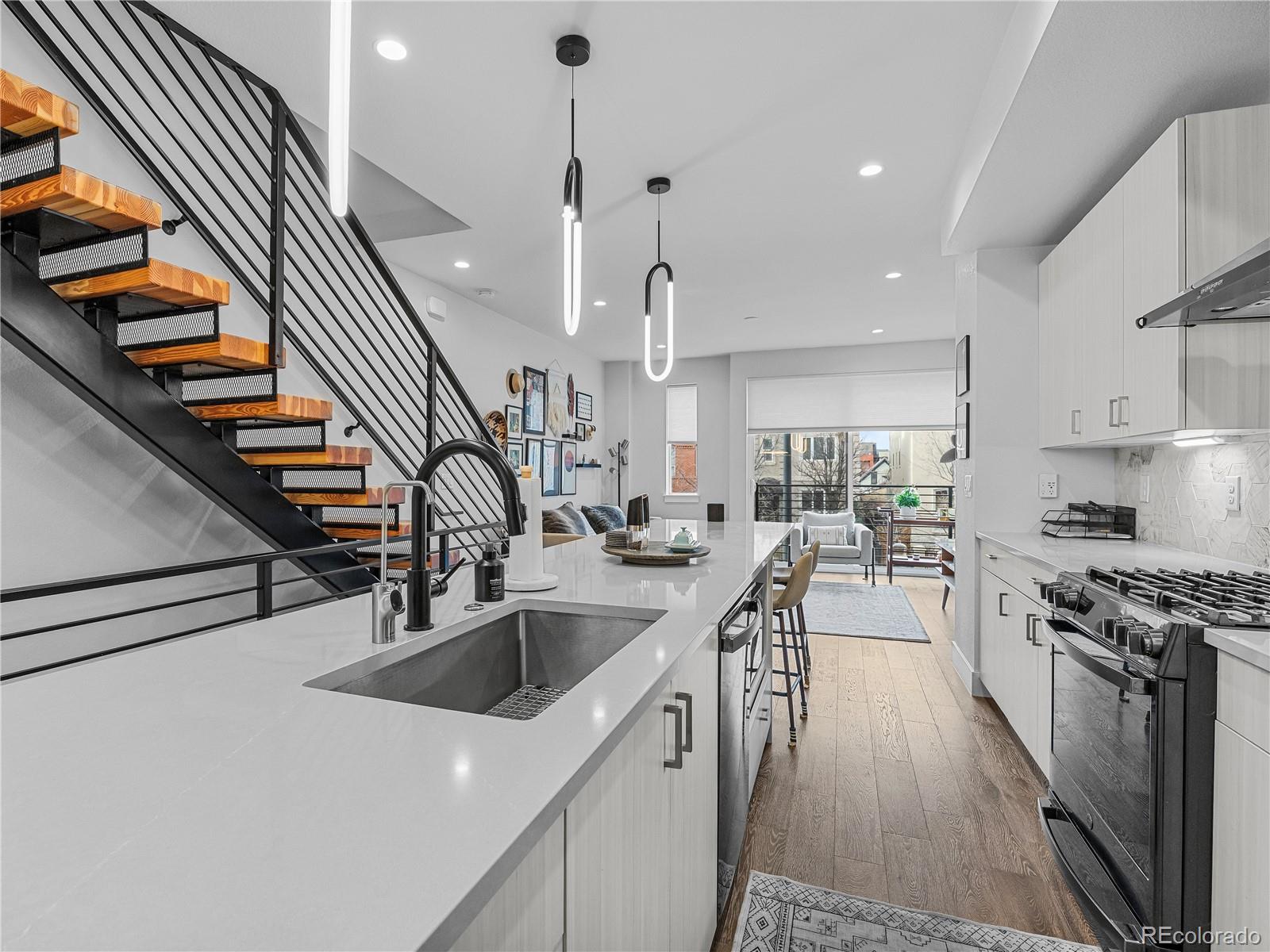 2350 Tremont Place, Unit 6 Denver, CO 80205 - Photo 9 of 40 a kitchen with sink stove and cabinets