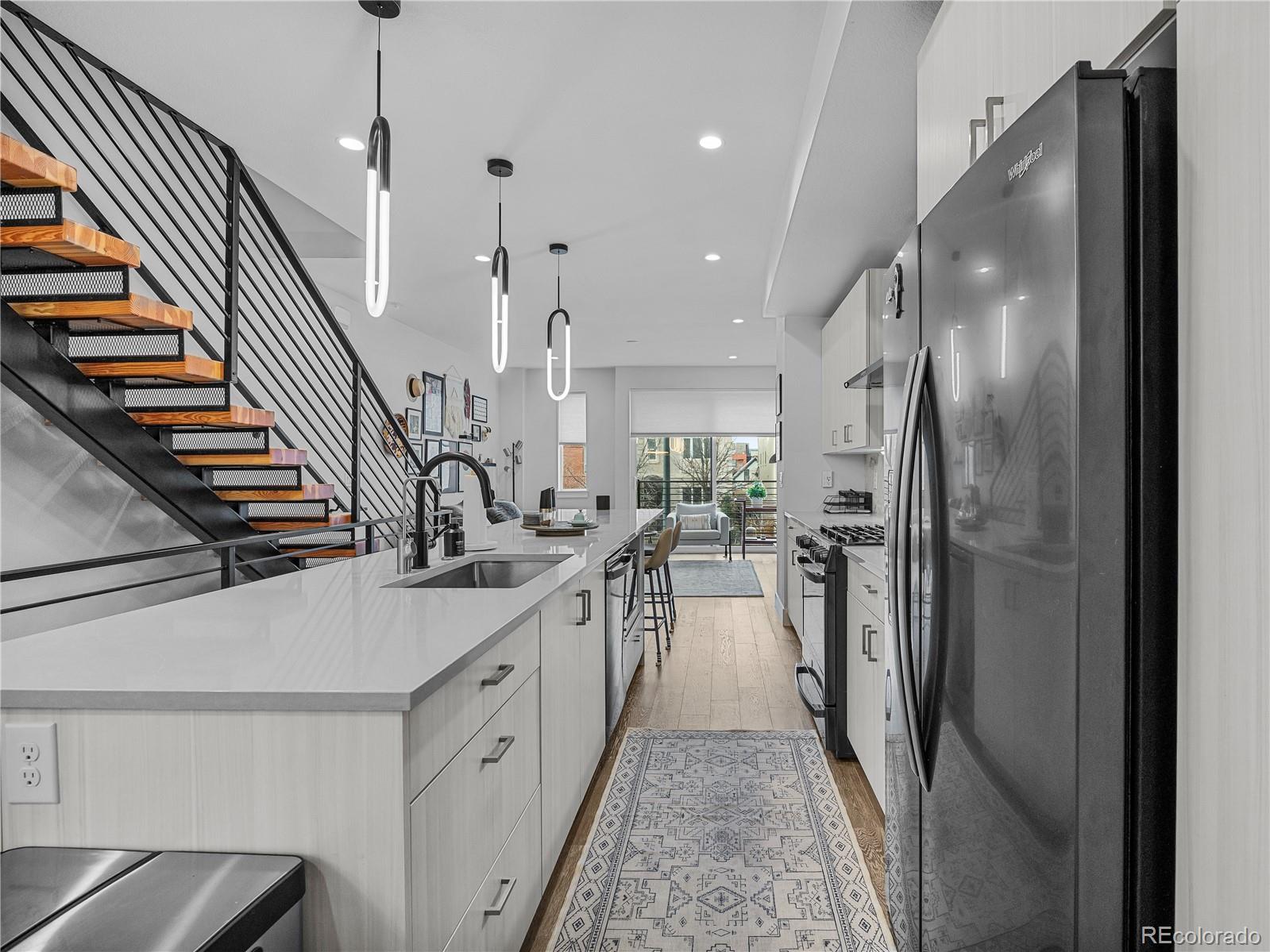 2350 Tremont Place, Unit 6 Denver, CO 80205 - Photo 10 of 40 a kitchen with sink a refrigerator and a view of living room