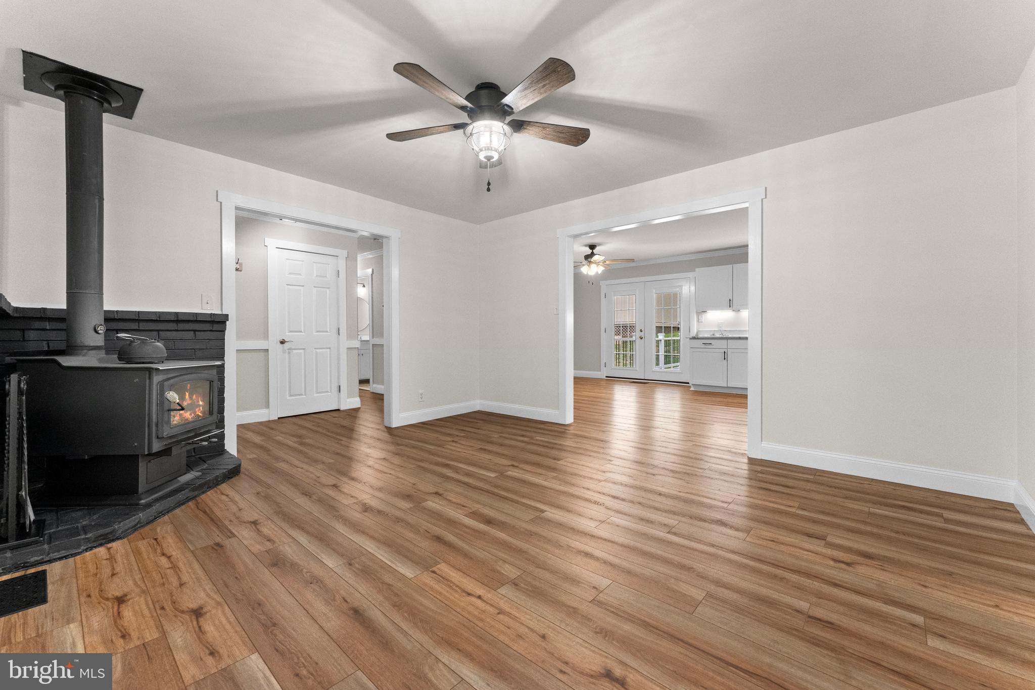 8 Colyer Road Fredericksburg, VA 22406 - Photo 15 of 56 a view of an empty room with wooden floor and a kitchen