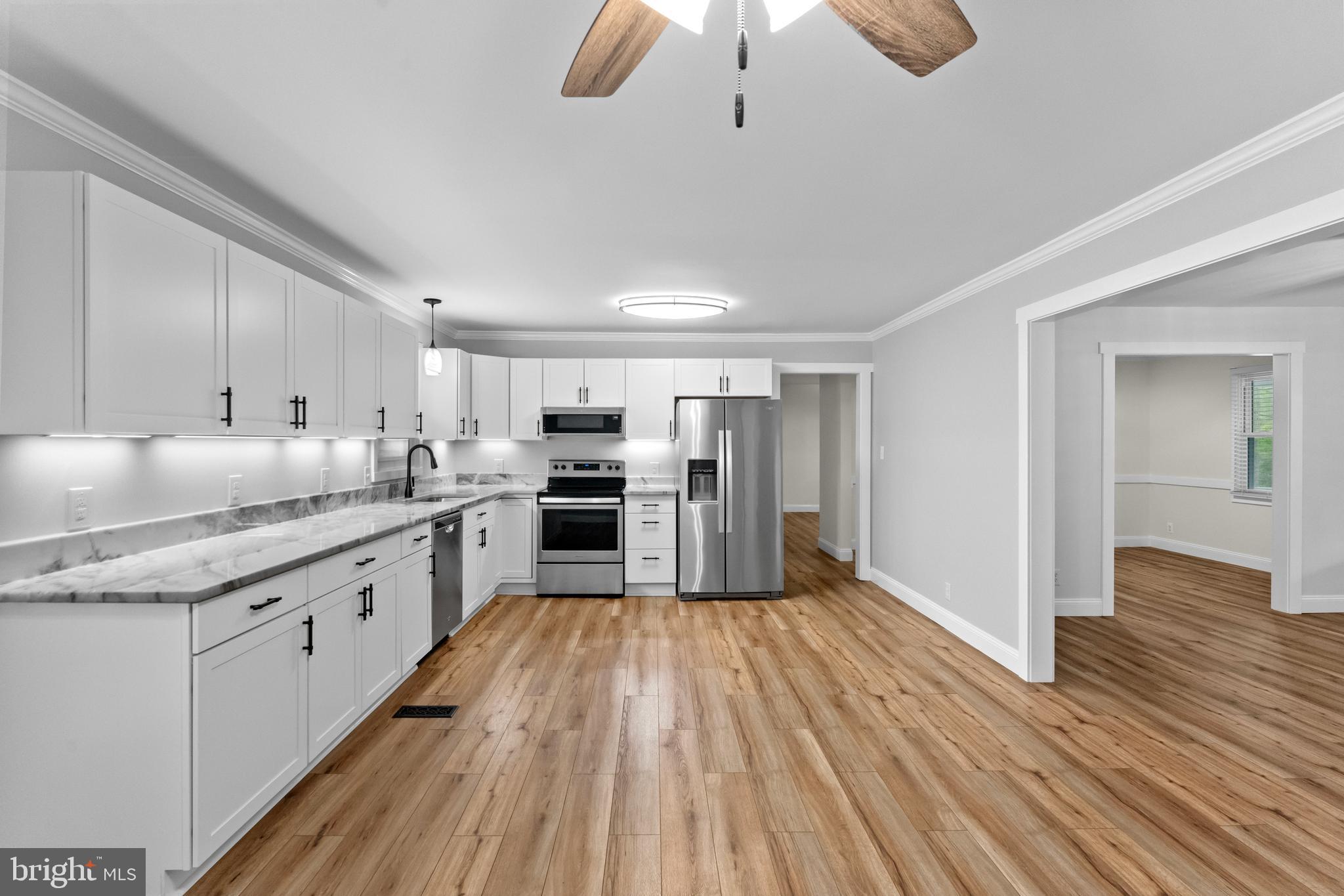 8 Colyer Road Fredericksburg, VA 22406 - Photo 22 of 56 a large kitchen with cabinets wooden floor and stainless steel appliances
