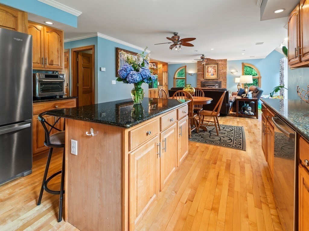 9 Santom Street Auburn, MA 01501 - Photo 4 of 42 a living room with stainless steel appliances kitchen island granite countertop furniture and a kitchen view