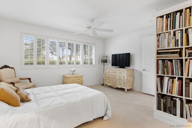 a bedroom with a bed window and flat screen tv