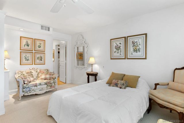 a bedroom with a bed and wall painting