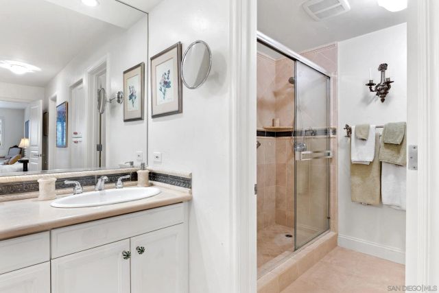 a bathroom with a double vanity sink mirror and shower