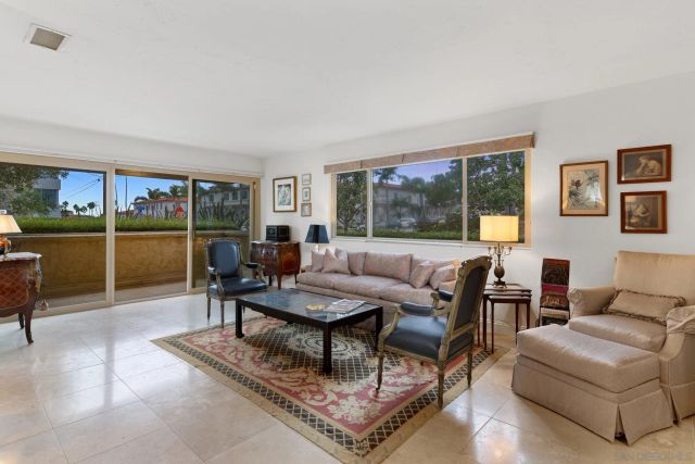 a living room with furniture a large window and a table