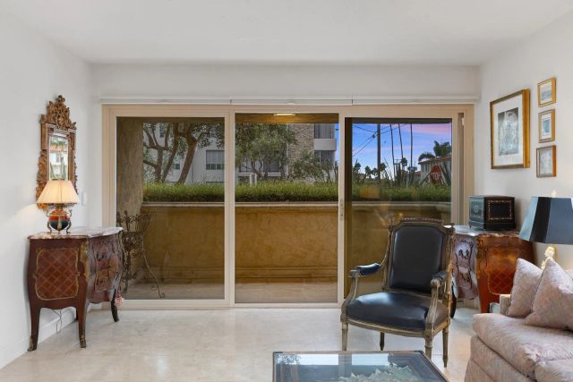 a living room with furniture and a floor to ceiling window
