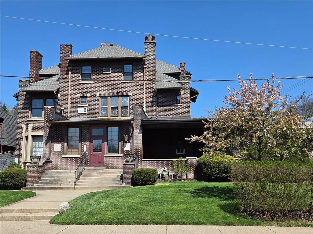 a front view of a house with garden