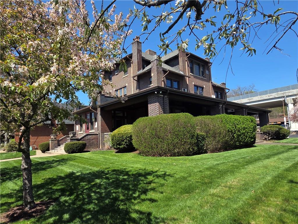 701 4th Street, Unit 2 Pittsburgh, PA 15215 - Photo 2 of 24 a view of a garden with plants and large trees