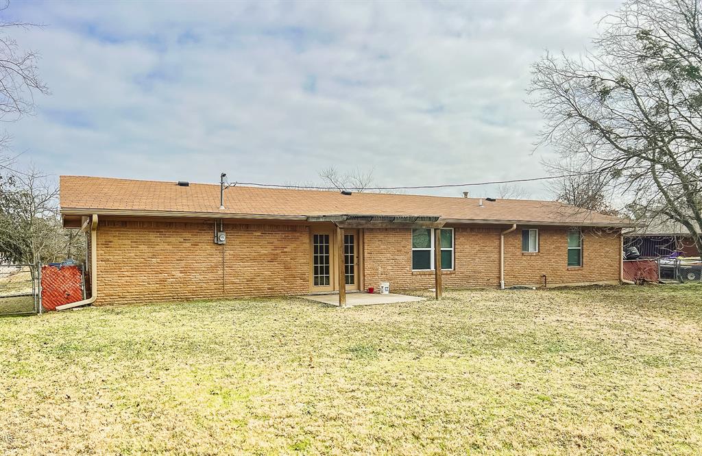 2501 Park Street Commerce, TX 75428 - Photo 17 of 24 a front view of a house with a garden
