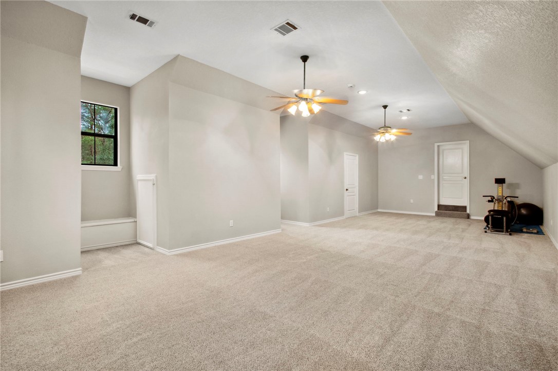 322 Whispering Meadow Magnolia, TX 77355 - Photo 21 of 34 a view of a livingroom with a furniture chandelier and a chandelier fan