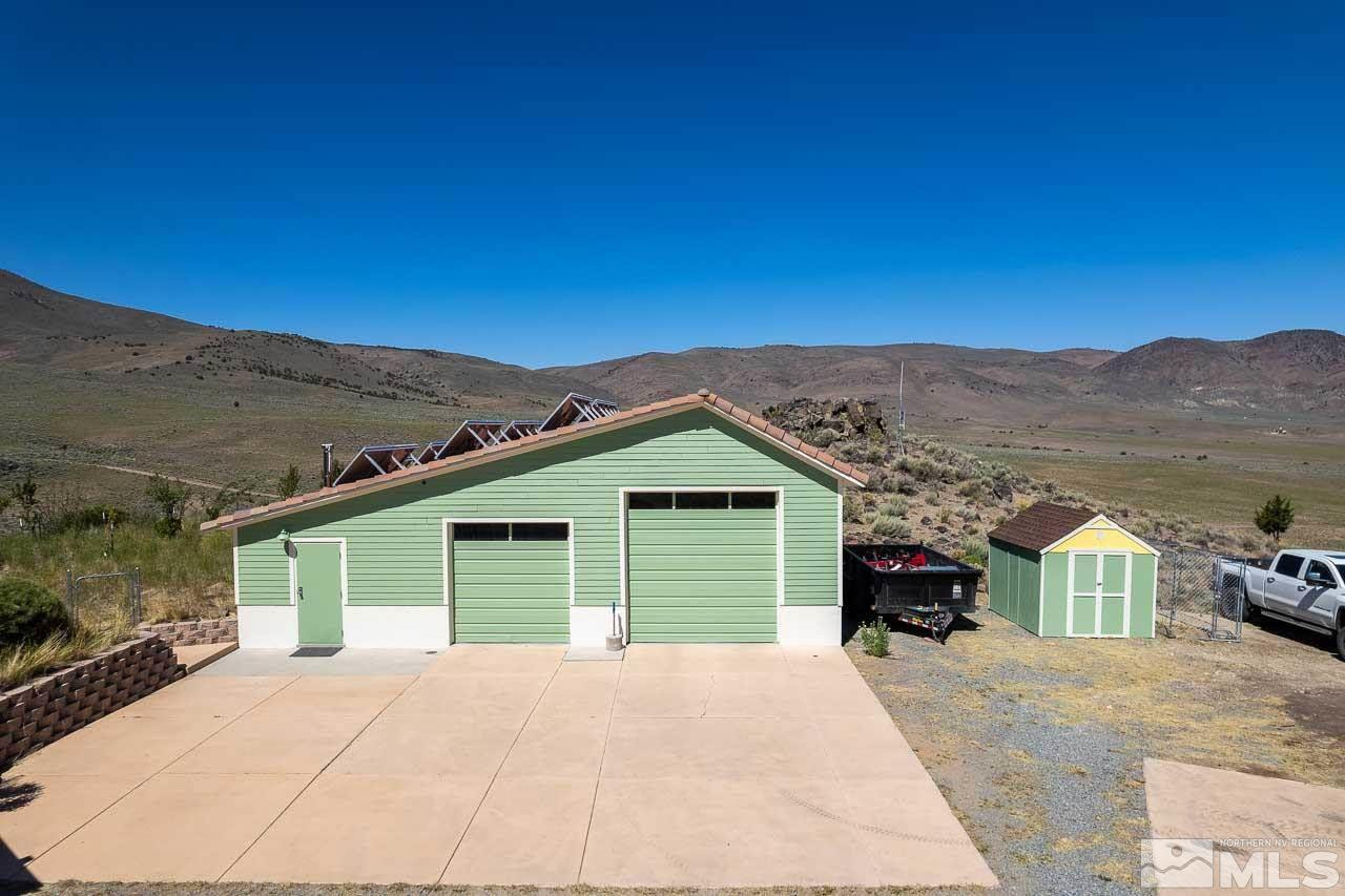 3415 Basque Oven Road Reno, NV 89510 - Photo 6 of 32 a front view of a house with a yard and mountain view
