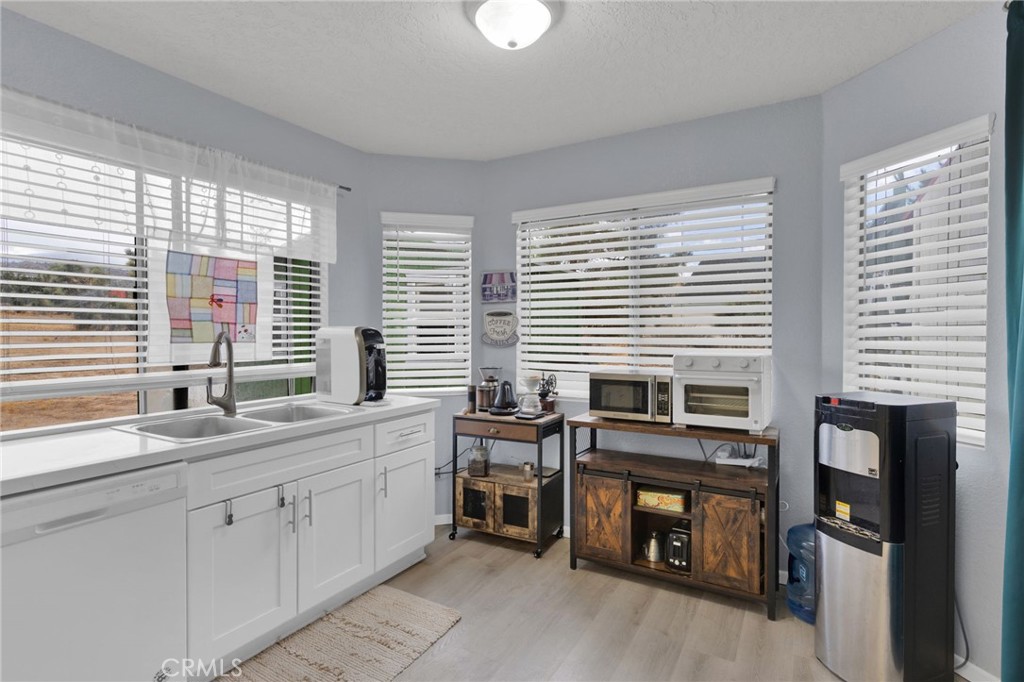 9224 Beekley Road Phelan, CA 92371 - Photo 11 of 52 a kitchen with stainless steel appliances granite countertop a stove a sink and a window