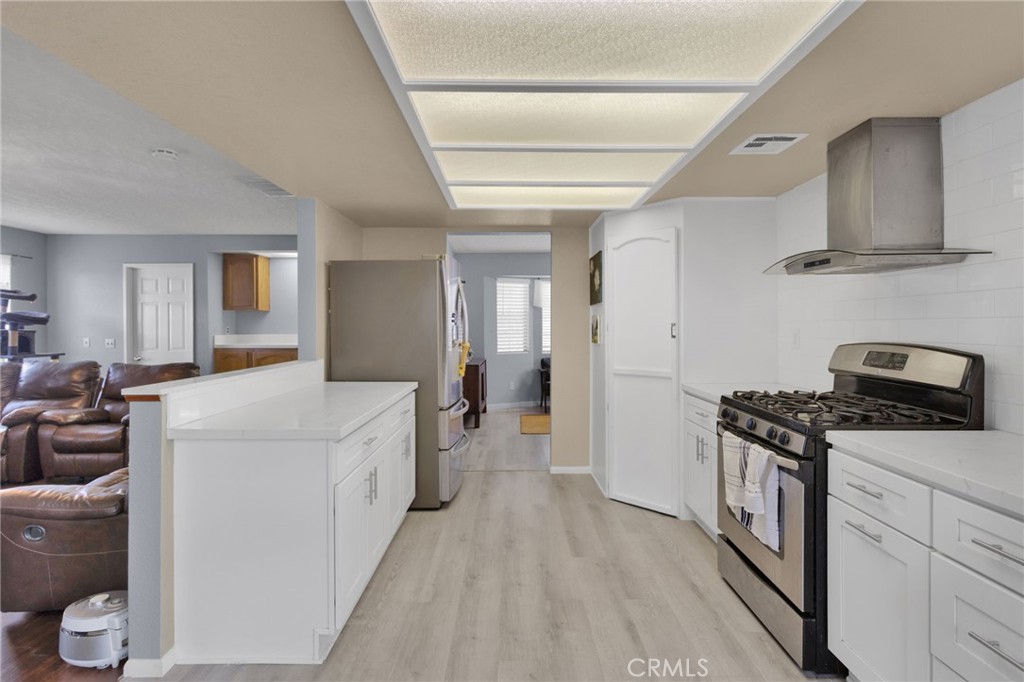 9224 Beekley Road Phelan, CA 92371 - Photo 12 of 52 a kitchen with a stove and a refrigerator