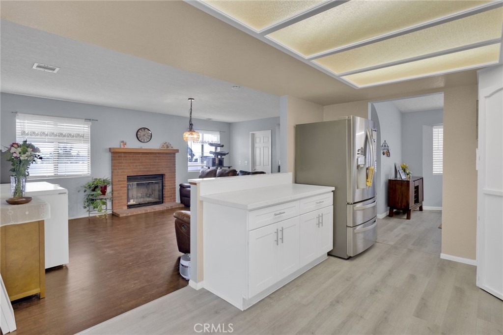 9224 Beekley Road Phelan, CA 92371 - Photo 13 of 52 a living room with furniture a fireplace and a chandelier