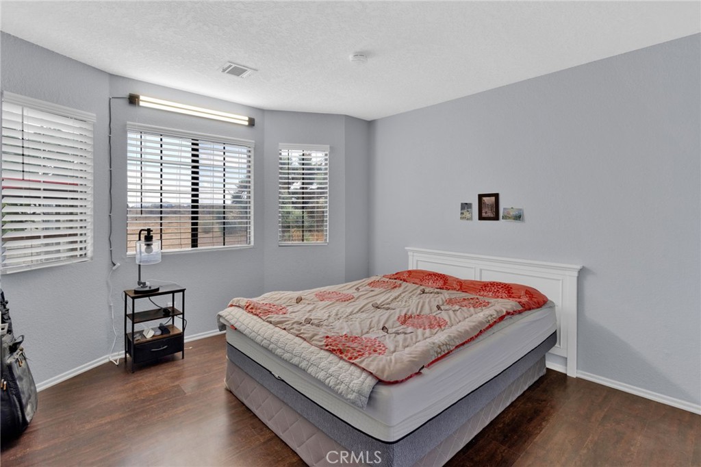 9224 Beekley Road Phelan, CA 92371 - Photo 17 of 52 a bed sitting in a bedroom next to a window