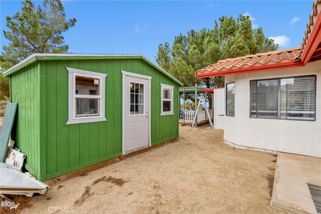 9224 Beekley Road Phelan, CA 92371 - Photo 39 of 52 a front view of a house with a yard and garage