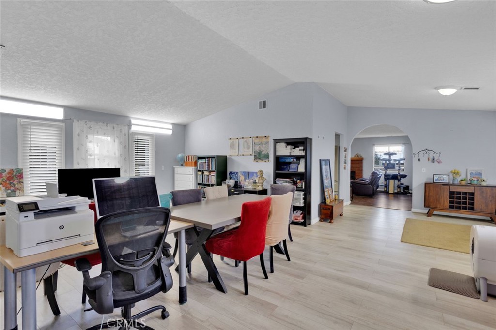9224 Beekley Road Phelan, CA 92371 - Photo 6 of 52 a living room with furniture a flat screen tv and a refrigerator
