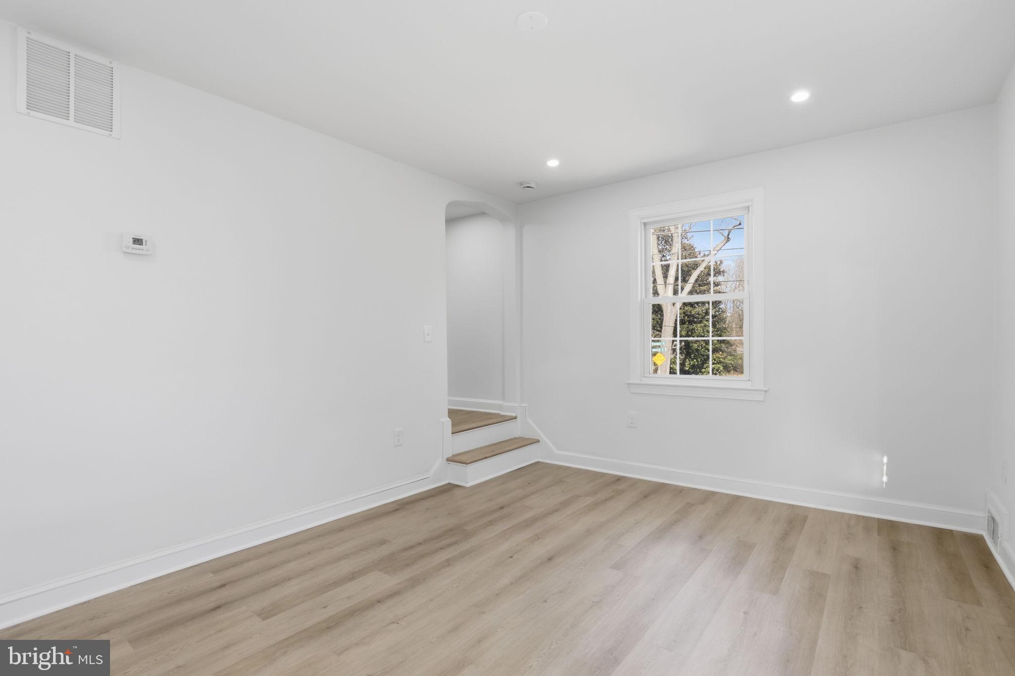 311 Ellsworth Drive Silver Spring, MD 20910 - Photo 22 of 65 an empty room with wooden floor and windows
