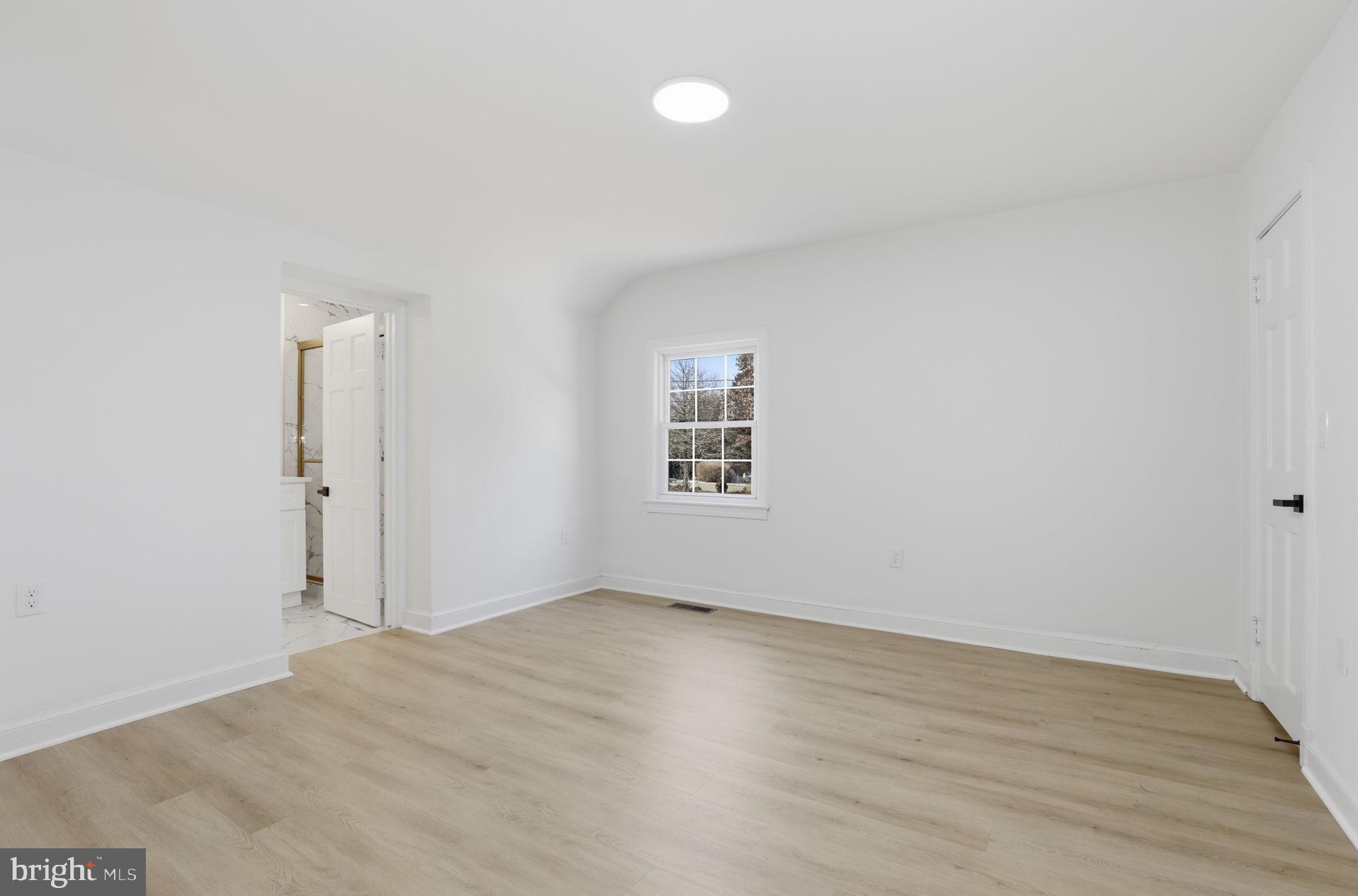 311 Ellsworth Drive Silver Spring, MD 20910 - Photo 26 of 65 an empty room with wooden floor and windows