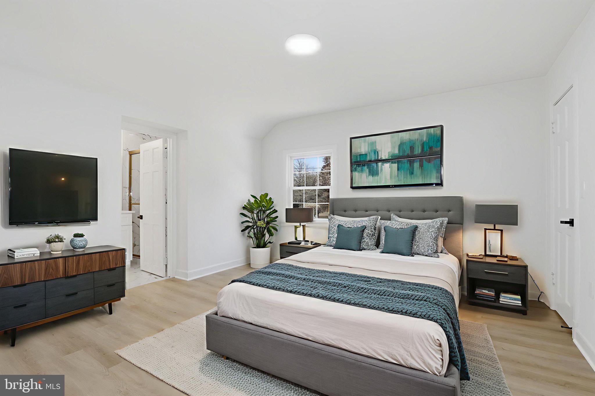 311 Ellsworth Drive Silver Spring, MD 20910 - Photo 27 of 65 a bedroom with a large bed and a flat screen tv