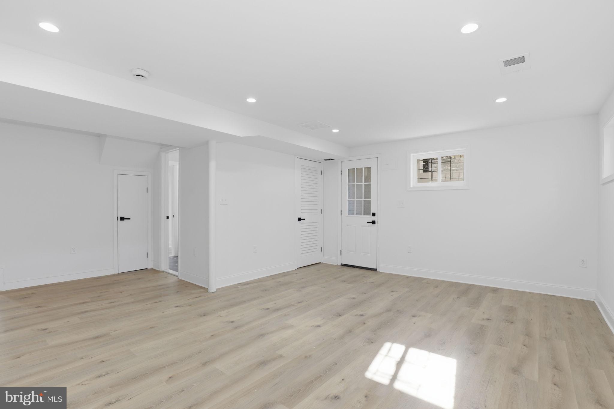 311 Ellsworth Drive Silver Spring, MD 20910 - Photo 45 of 65 an empty room with wooden floor and windows