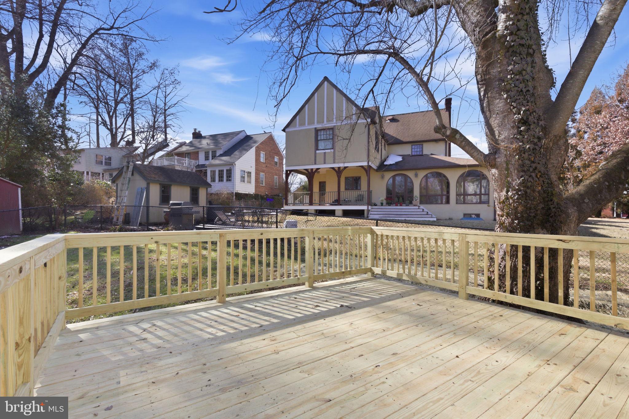 311 Ellsworth Drive Silver Spring, MD 20910 - Photo 57 of 65 a view of a house with a wooden deck next to a yard