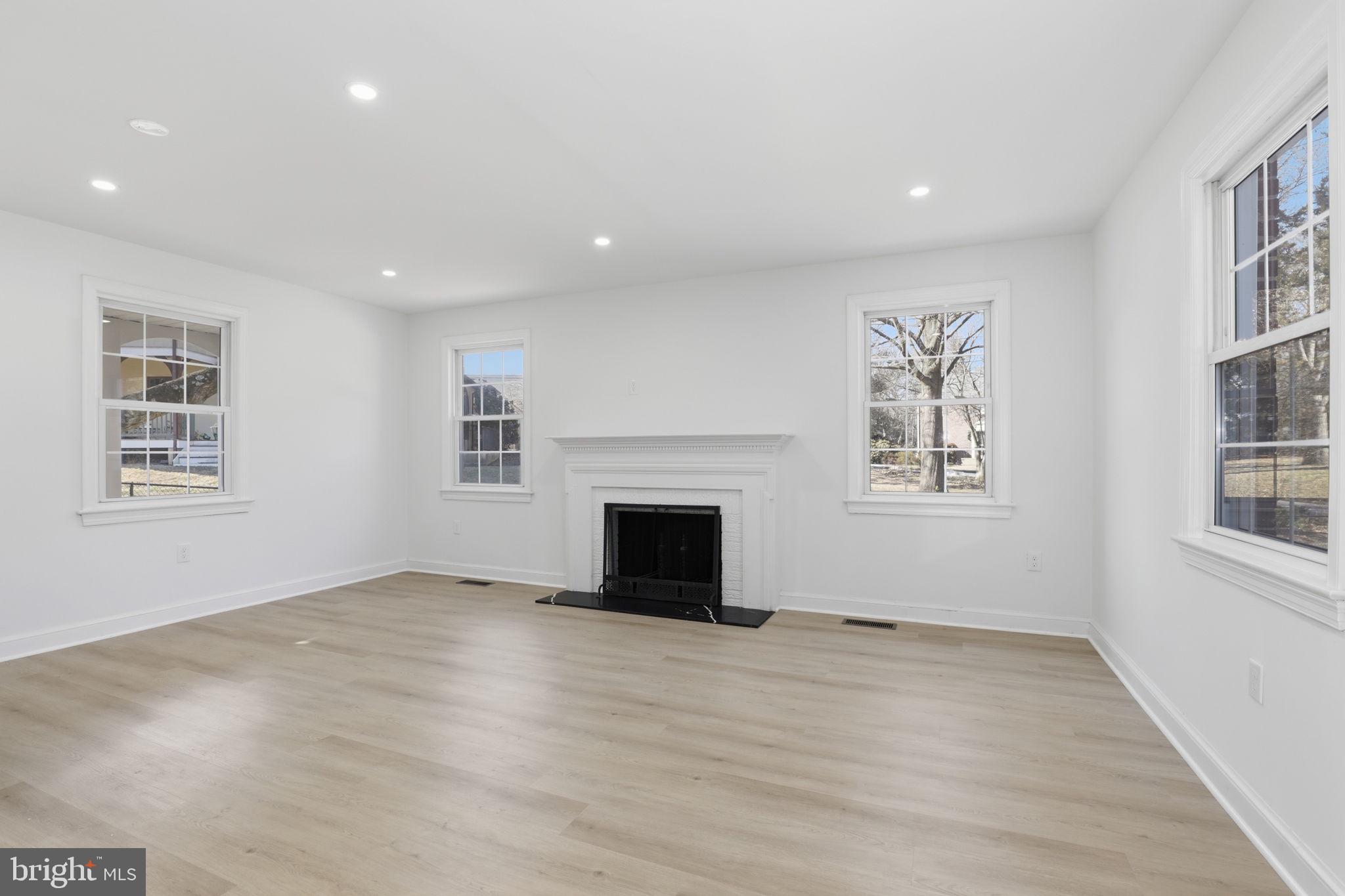 311 Ellsworth Drive Silver Spring, MD 20910 - Photo 6 of 65 an empty room with windows and fireplace