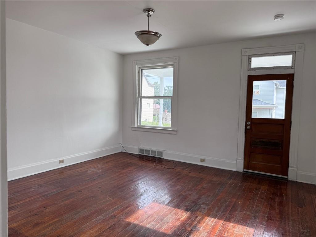 441 5th Street Donora, PA 15033 - Photo 5 of 16 a view of an empty room with wooden floor and a window