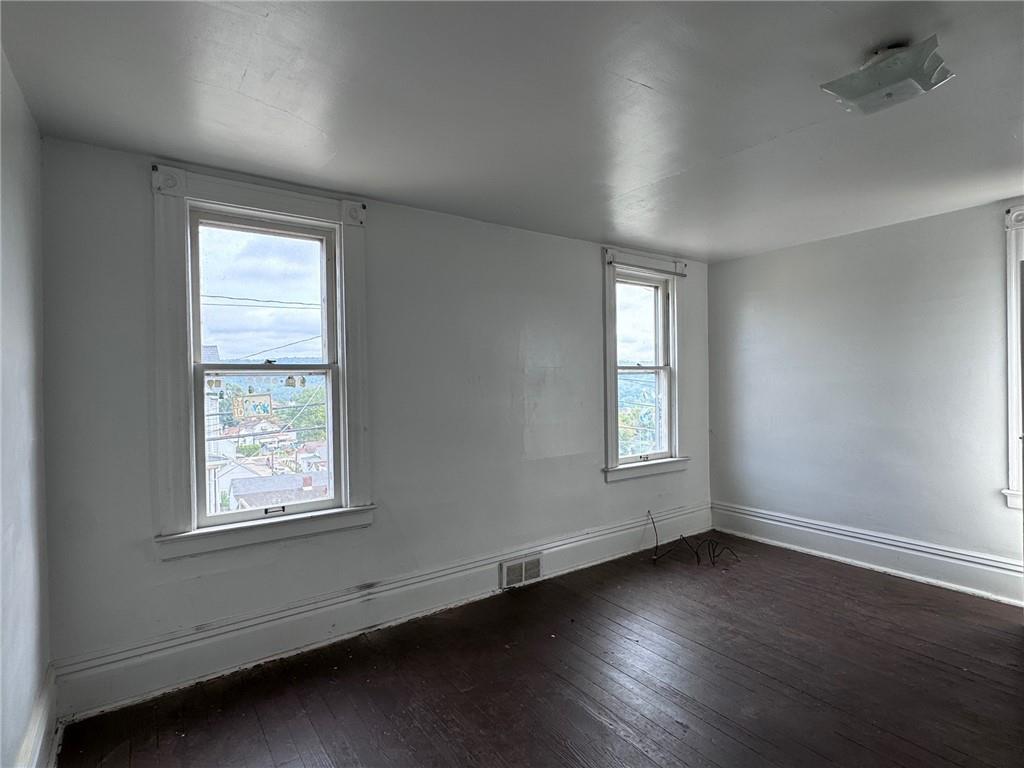 441 5th Street Donora, PA 15033 - Photo 8 of 16 an empty room with wooden floor and windows