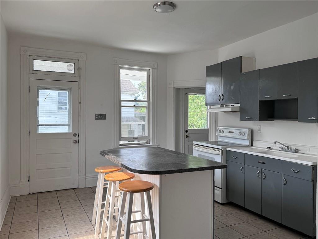 441 5th Street Donora, PA 15033 - Photo 10 of 16 a kitchen with stainless steel appliances granite countertop a sink a stove and a window