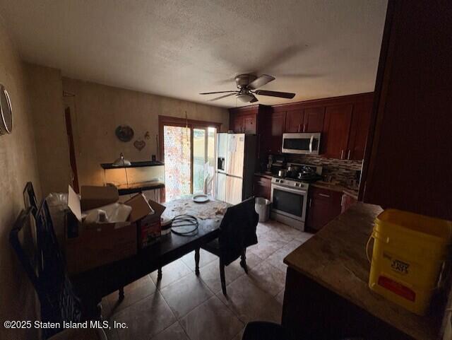 202 Chestnut Avenue Staten Island, NY 10305 - Photo 13 of 24 a kitchen with stainless steel appliances kitchen island granite countertop a stove top oven a sink a dining table and chairs with wooden floor
