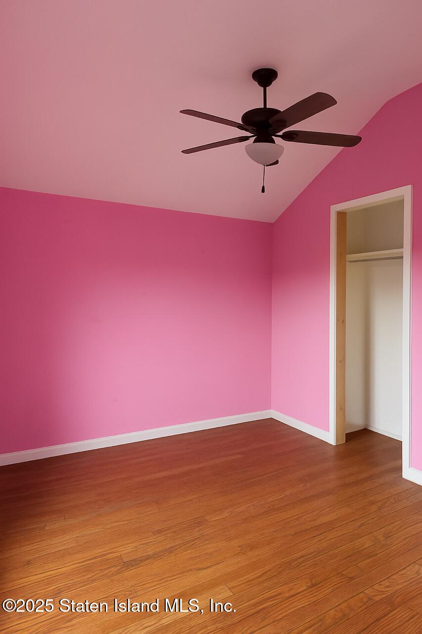 202 Chestnut Avenue Staten Island, NY 10305 - Photo 7 of 24 a view of empty room with wooden floor and fan