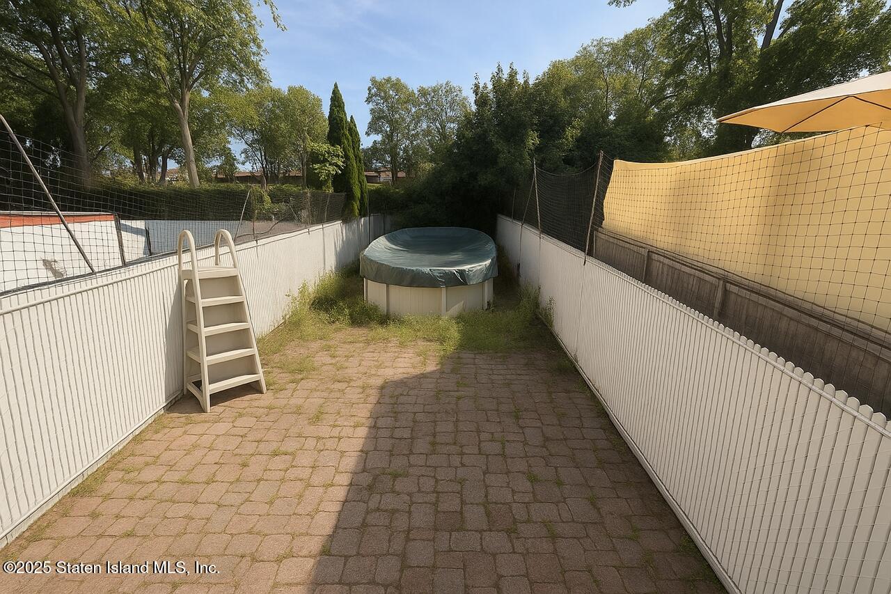 202 Chestnut Avenue Staten Island, NY 10305 - Photo 9 of 24 a view of a patio with a table and chairs