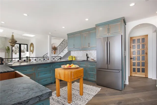 a kitchen with stainless steel appliances granite countertop a stove and a sink
