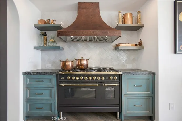 a kitchen with stainless steel appliances granite countertop a stove and a refrigerator