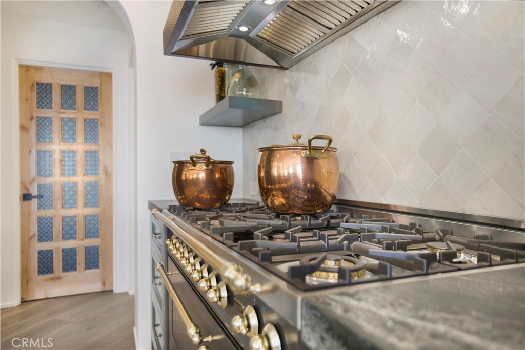 825 Coast View Drive Laguna Beach, CA 92651 - Photo 15 of 63 a kitchen with a stove and a chandelier