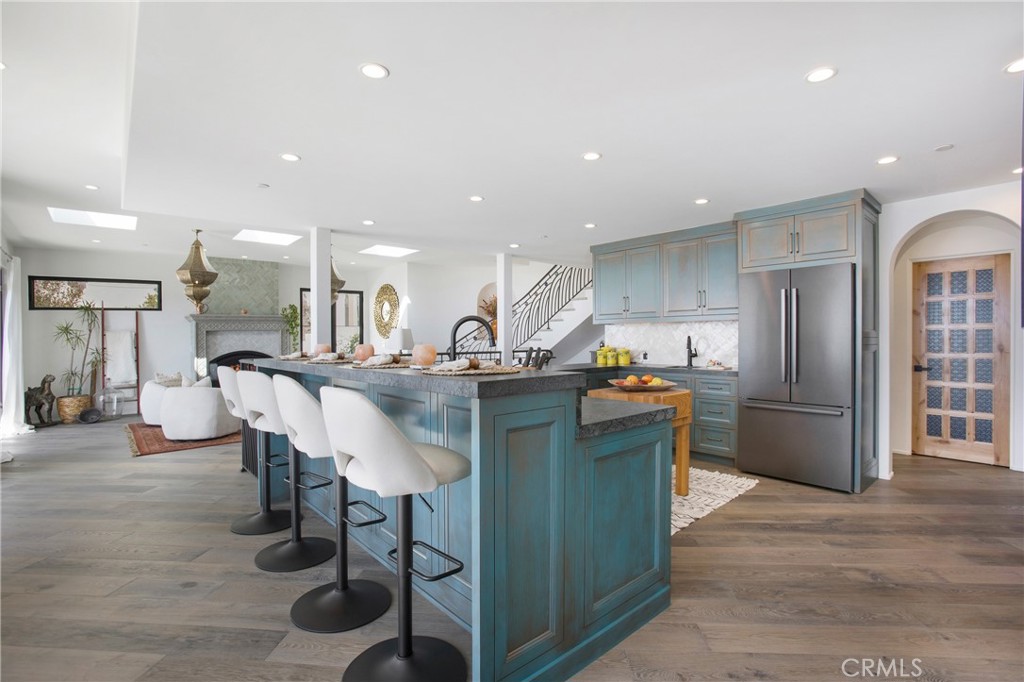 825 Coast View Drive Laguna Beach, CA 92651 - Photo 16 of 63 a kitchen with stainless steel appliances kitchen island granite countertop a table and chairs in it
