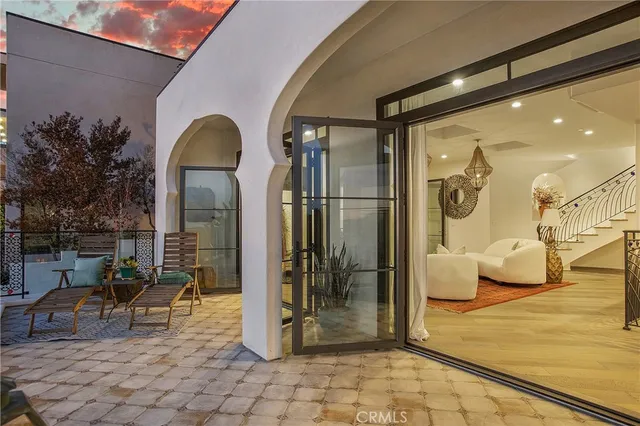 a living room with a large bed and a flat screen tv