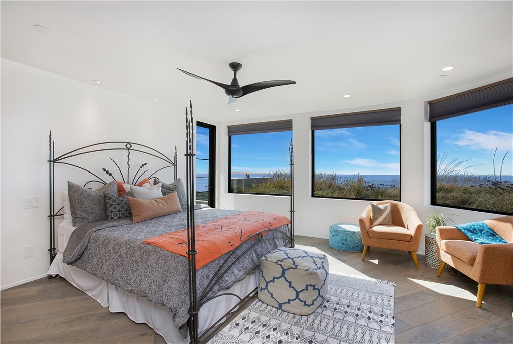 825 Coast View Drive Laguna Beach, CA 92651 - Photo 31 of 63 a living room with a large bed and a flat screen tv