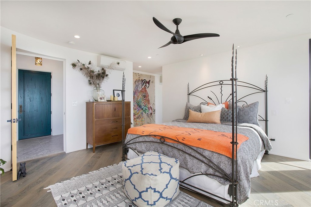 825 Coast View Drive Laguna Beach, CA 92651 - Photo 33 of 63 a bedroom with a bed and ceiling fan
